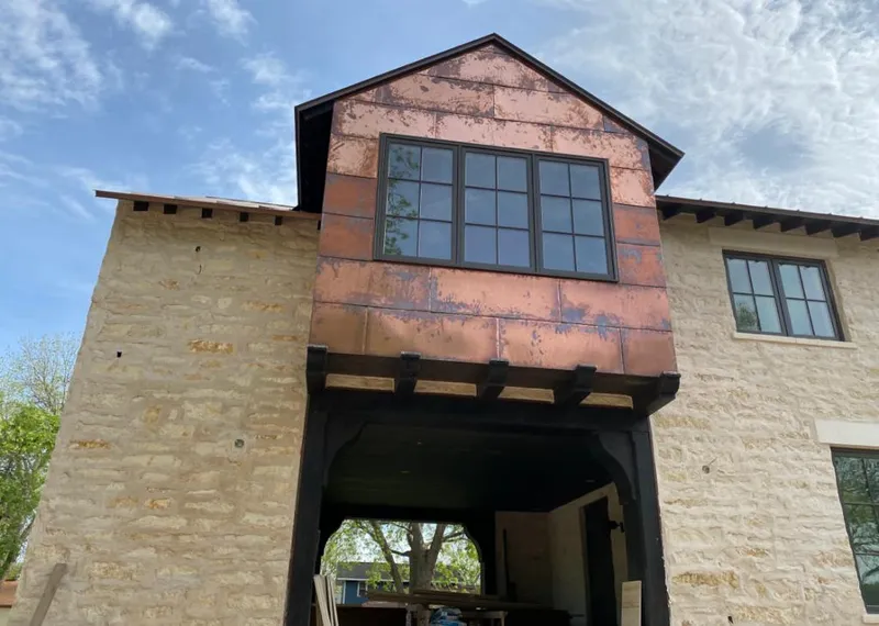 Copper metal panel facade on a stone building for Skylight Installation in Frederick